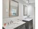 Double vanity bathroom with marble countertops and updated fixtures at 1681 Macdonnell Ct, Palm Harbor, FL 34684