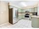 Kitchen with stainless steel appliances and light green cabinets at 3809 Windtree Ct, Brandon, FL 33511