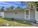 Newly painted gray exterior with a fenced yard at 12304 N Oakleaf Ave, Tampa, FL 33612