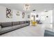 Bright living area featuring a gray sectional sofa and a statement yellow chair at 12304 N Oakleaf Ave, Tampa, FL 33612