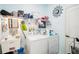 Bright laundry room with washer, dryer, and utility sink at 289 Dandelion Ct, Spring Hill, FL 34606