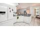Kitchen with white cabinets, a breakfast bar and a view of the living room at 289 Dandelion Ct, Spring Hill, FL 34606