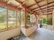 Enclosed back porch featuring a concrete floor and natural light at 26831 Chianina Dr, Wesley Chapel, FL 33544