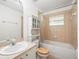 Well-lit bathroom features a shower and tub, wood accents and vanity at 26831 Chianina Dr, Wesley Chapel, FL 33544