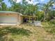Features a well-maintained attached garage, adjacent to an open, wooden-roofed patio at 26831 Chianina Dr, Wesley Chapel, FL 33544