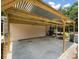 Concrete patio and a wood structure providing additional shade and outdoor space at 26831 Chianina Dr, Wesley Chapel, FL 33544