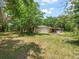 Charming single-story home with attached garage and mature trees on a sunny day at 26831 Chianina Dr, Wesley Chapel, FL 33544