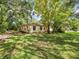 Cozy single-story home with a well-maintained lawn and mature trees offering ample shade at 26831 Chianina Dr, Wesley Chapel, FL 33544