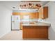 Updated kitchen with a breakfast bar, wooden cabinets, granite countertops, and tile flooring at 26831 Chianina Dr, Wesley Chapel, FL 33544