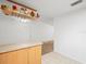 Corner kitchen showcasing a breakfast bar, wooden cabinets, countertops, and tile flooring at 26831 Chianina Dr, Wesley Chapel, FL 33544