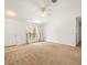 Spacious living room with neutral carpet, a ceiling fan, and natural light from a window at 26831 Chianina Dr, Wesley Chapel, FL 33544