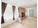 Inviting living room with brick fireplace, tile floor, and large windows at 26831 Chianina Dr, Wesley Chapel, FL 33544