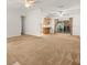 Spacious living area with neutral carpet, ceiling fans, and an open layout to the kitchen at 26831 Chianina Dr, Wesley Chapel, FL 33544