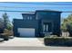 Contemporary new construction home featuring a two-car garage and dark exterior paint at 4716 W Euclid Ave, Tampa, FL 33629