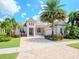 Charming home featuring a neutral color scheme, beautiful landscaping, and a brick paver driveway at 717 Manns Harbor Dr, Apollo Beach, FL 33572