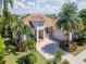 Beautiful home showcasing lush landscaping, a charming porch, and a well-manicured lawn at 717 Manns Harbor Dr, Apollo Beach, FL 33572