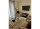 Cozy living room featuring comfortable seating and a large TV at 9481 Highland Oak Dr # 505, Tampa, FL 33647
