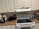 Modern kitchen with electric range and overhead vent at 9481 Highland Oak Dr # 505, Tampa, FL 33647