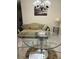Dining area with glass table, chairs, and a beige sofa at 9481 Highland Oak Dr # 505, Tampa, FL 33647