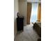 Well-lit bedroom with dresser and relaxing chair at 9481 Highland Oak Dr # 505, Tampa, FL 33647