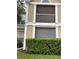 Exterior view of building showing a tan building with white accents, balcony, and landscaping at 9481 Highland Oak Dr # 505, Tampa, FL 33647
