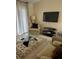 Cozy living room featuring comfortable seating and a large TV at 9481 Highland Oak Dr # 505, Tampa, FL 33647