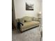 Living Room with beige sofa and throw blanket at 9481 Highland Oak Dr # 505, Tampa, FL 33647