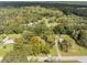 Aerial showing home surrounded by lush vegetation at 26831 Chianina Dr, Wesley Chapel, FL 33544