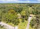 Aerial view showing home's location and surrounding wooded area at 26831 Chianina Dr, Wesley Chapel, FL 33544
