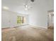 Bright living room with carpet, ceiling fan and window at 26831 Chianina Dr, Wesley Chapel, FL 33544
