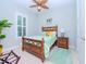Cozy bedroom with wood framed bed and ocean decor at 717 Manns Harbor Dr, Apollo Beach, FL 33572