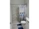 Clean bathroom with shower, toilet, and nautical-themed shower curtain at 717 Manns Harbor Dr, Apollo Beach, FL 33572