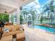 Inviting screened pool and patio area with water feature and canal view at 717 Manns Harbor Dr, Apollo Beach, FL 33572