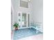 Bright entryway with light flooring, bench, and large front door at 717 Manns Harbor Dr, Apollo Beach, FL 33572