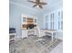 Bright home office featuring built-in white cabinets and a large desk at 717 Manns Harbor Dr, Apollo Beach, FL 33572
