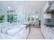 Modern kitchen with white cabinets, large island, and stainless steel appliances at 717 Manns Harbor Dr, Apollo Beach, FL 33572