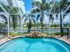 Relaxing screened pool with waterfall feature and canal view at 717 Manns Harbor Dr, Apollo Beach, FL 33572