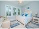 Bright bedroom with a comfortable bed and seating area at 717 Manns Harbor Dr, Apollo Beach, FL 33572