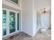 Front porch with glass door, rocking chairs, and tile flooring at 717 Manns Harbor Dr, Apollo Beach, FL 33572