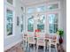 Bright dining room with white table and chairs, and large windows at 717 Manns Harbor Dr, Apollo Beach, FL 33572