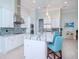 Modern kitchen with white cabinets, large island, and stainless steel appliances at 717 Manns Harbor Dr, Apollo Beach, FL 33572