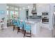 Modern kitchen with white cabinets, large island, and stainless steel appliances at 717 Manns Harbor Dr, Apollo Beach, FL 33572