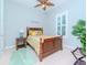 Charming bedroom with wood bed frame, ceiling fan, and leafy plant at 717 Manns Harbor Dr, Apollo Beach, FL 33572