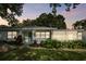 Light green home with a screened porch at dusk at 731 74Th N St, St Petersburg, FL 33710