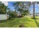 Single story house with flowering bushes and large tree at 731 74Th N St, St Petersburg, FL 33710