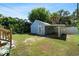Backyard featuring a detached garage with a carport, offering ample parking and storage space surrounded by green foliage at 860 19 N Ave, St Petersburg, FL 33704