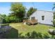 Spacious backyard with a deck area, perfect for outdoor entertaining and relaxation, surrounded by grass and trees at 860 19 N Ave, St Petersburg, FL 33704