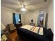 Bright bedroom featuring hardwood floors, ceiling fan, and well-lit dresser with decorative lamp at 860 19 N Ave, St Petersburg, FL 33704