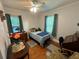 Cozy bedroom with hardwood floors, ceiling fan, and natural light from two windows at 860 19 N Ave, St Petersburg, FL 33704