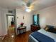Bedroom with hardwood floors, ceiling fan, and dresser, with view into adjoining rooms at 860 19 N Ave, St Petersburg, FL 33704